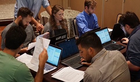 Photo of a group of adult students learning how to use software