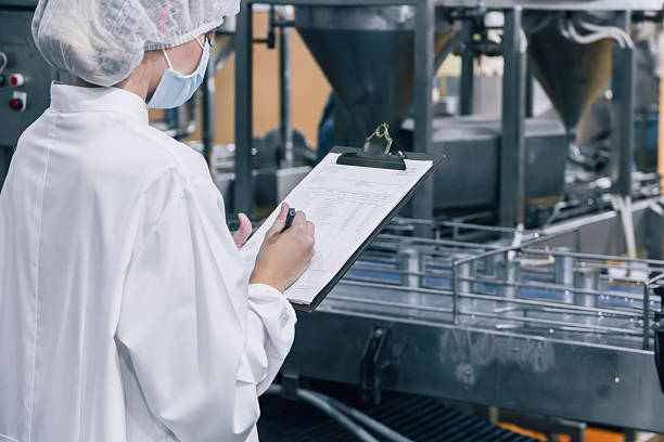 Person in white protective clothing performing an audit